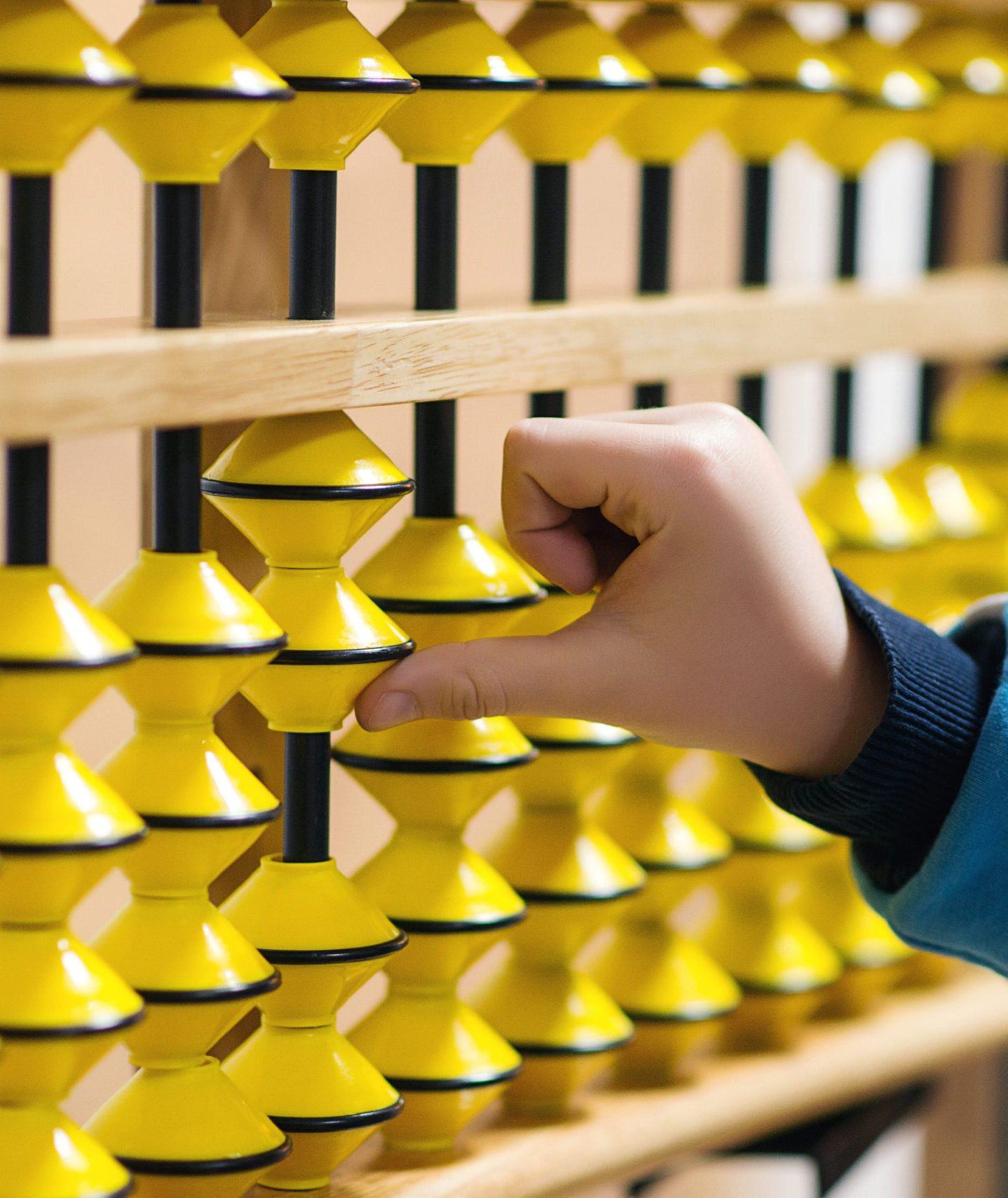 smart kid counting on soroban abacus. child studing at mental arithmetic school.